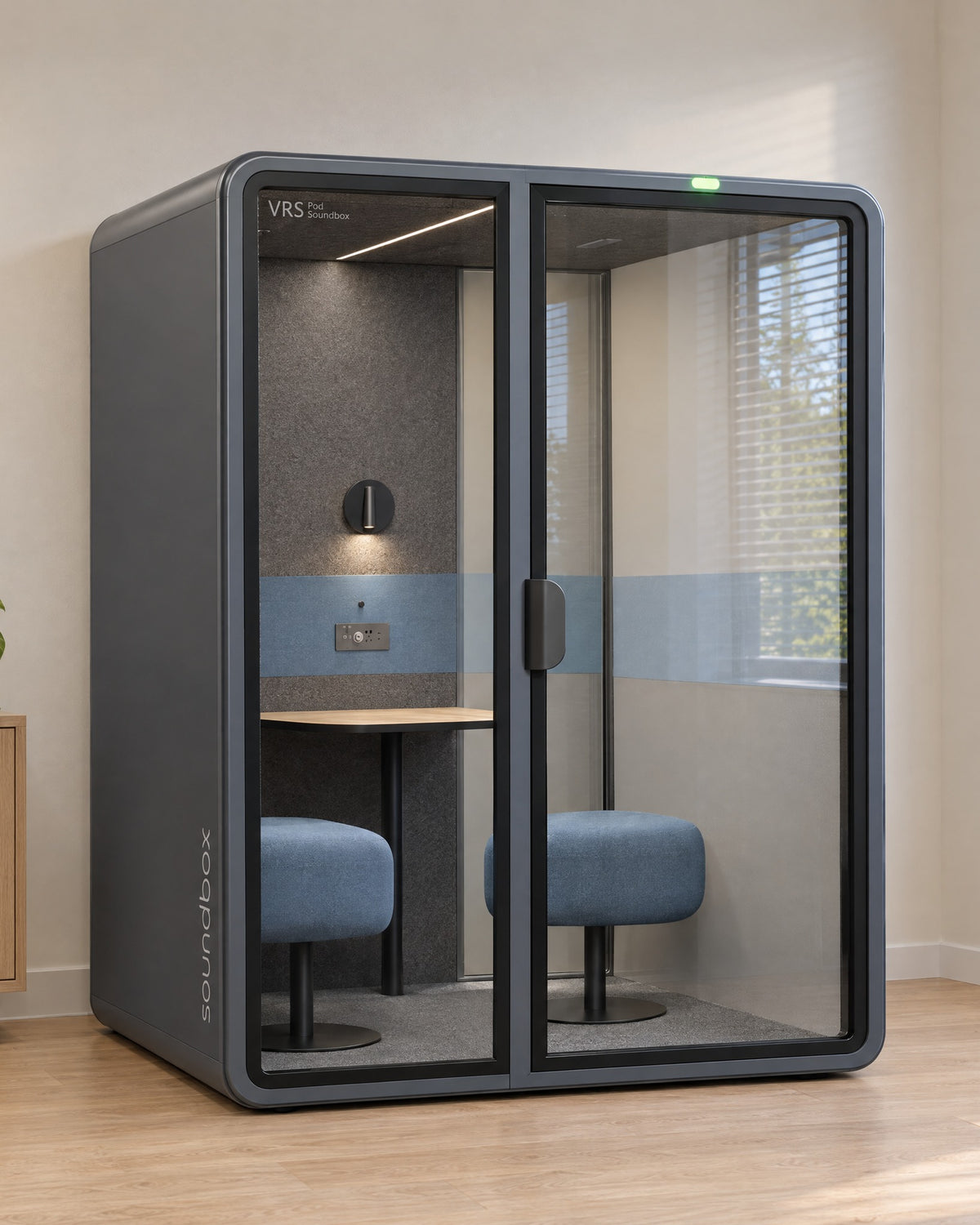 SoundBox VRS Comfort in a bright consulting office by a window, door closed, green available light on. Illustration.
