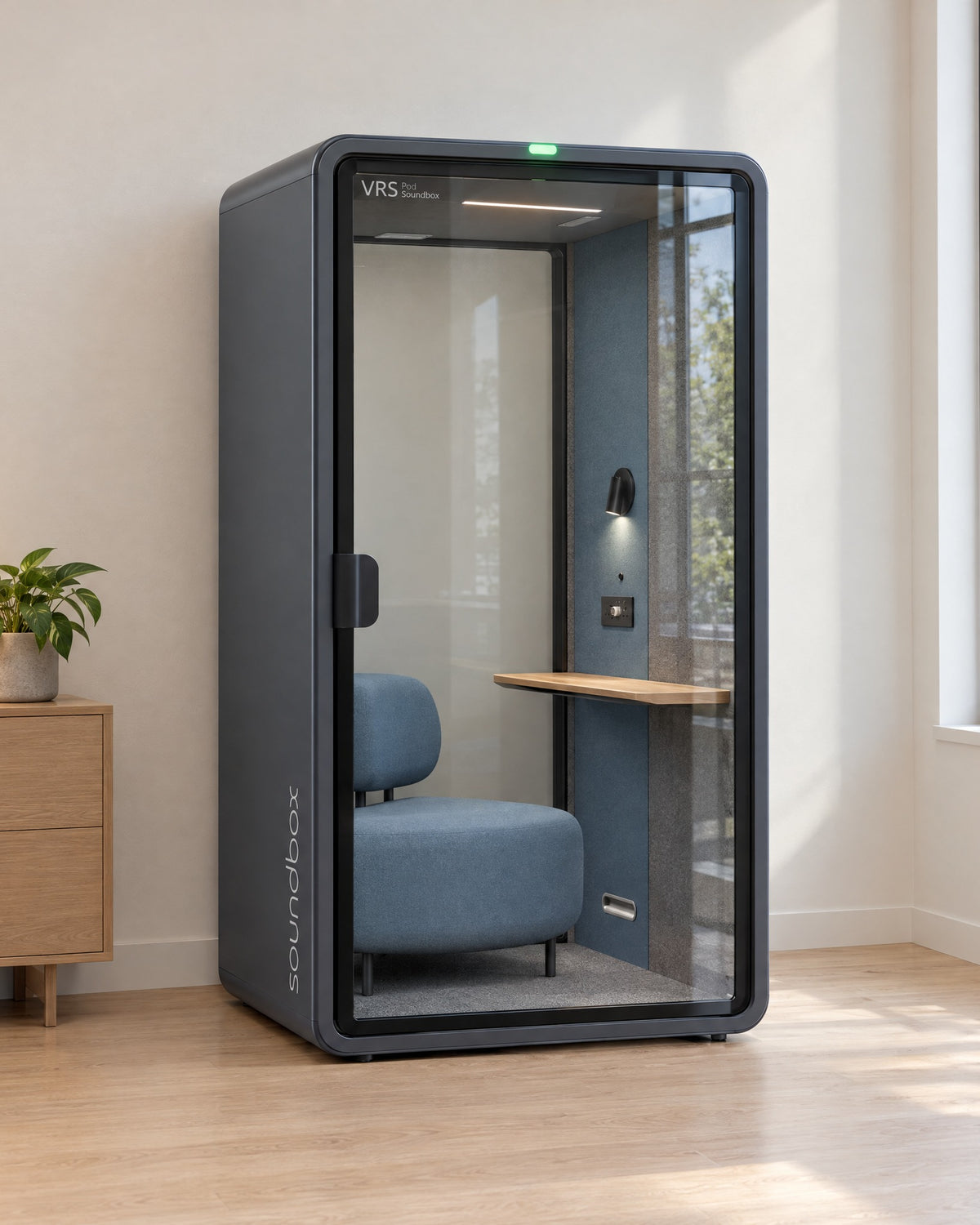SoundBox VRS Single Comfort in a bright office corner by a window, door closed, green available light on. Illustration.