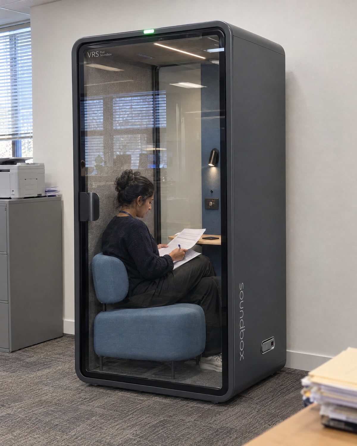 SoundBox VRS Single Comfort in an accounting office, one person inside reading documents. Illustration.
