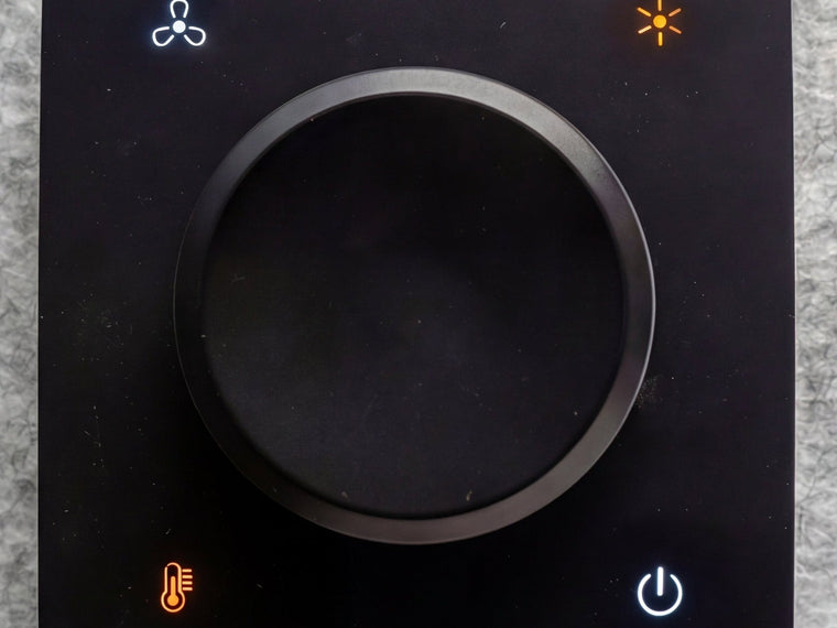 Close up of the fan and light control dial inside a Quiet Cabins room