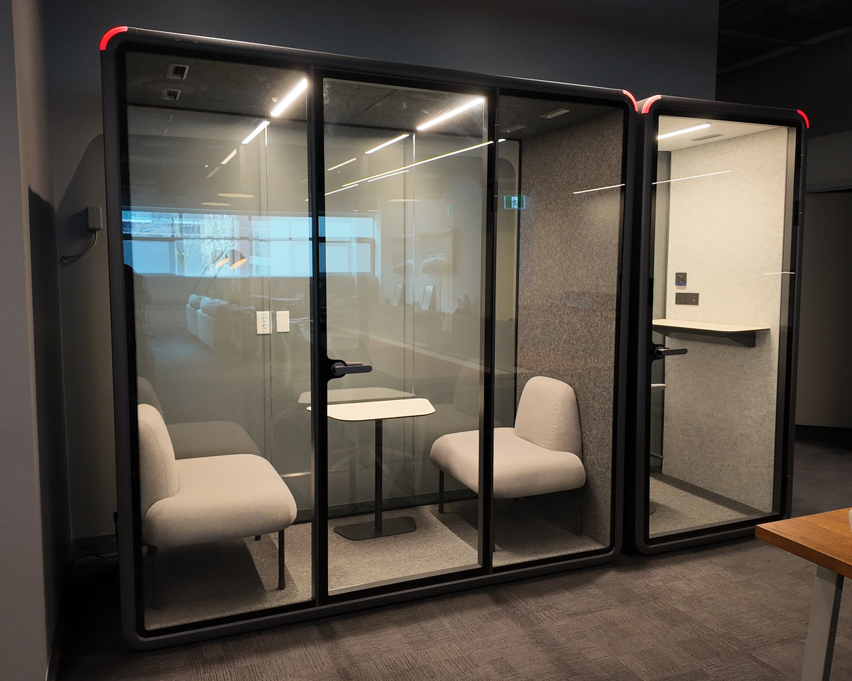 A Quiet Cabins Double Booth and Single Booth installed side by side on an office floor in Toronto