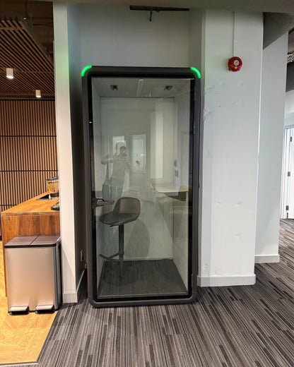Single Work Booth in a corridor beside the kitchen, backed against a slatted wood wall ::real