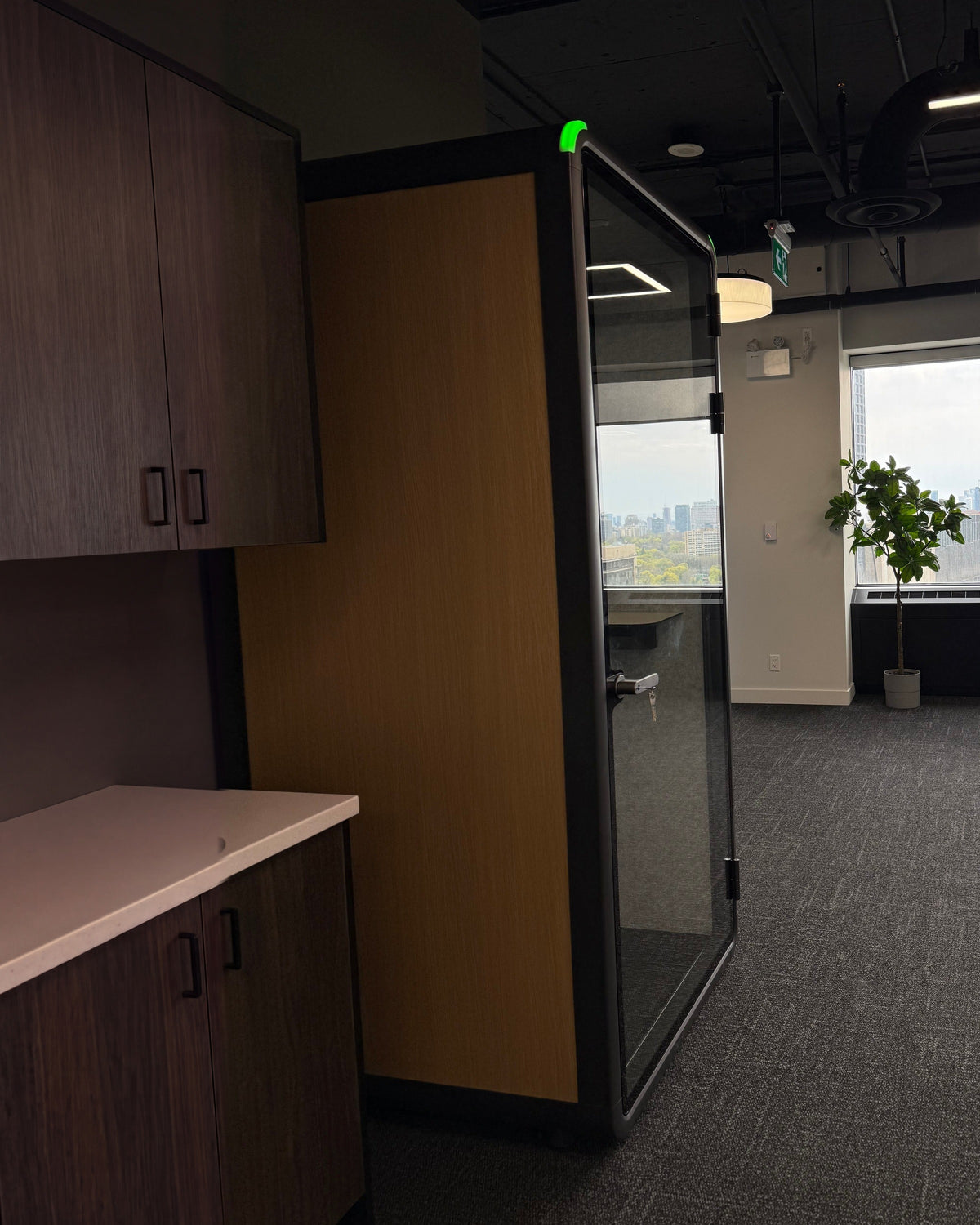 Single Work Booth in a corner office with a city view, sitting in the open plan ::real
