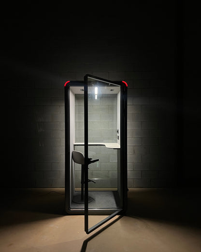 The occupancy light glowing red across a dark room. Anyone walking past can see the booth is in use ::detail