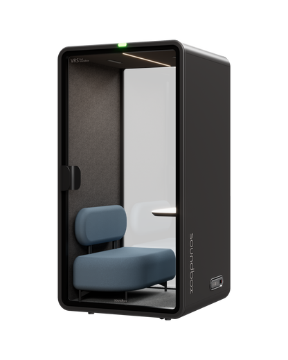 SoundBox VRS Single Comfort pod: graphite shell, full-height glass door, dusty blue lounge armchair inside