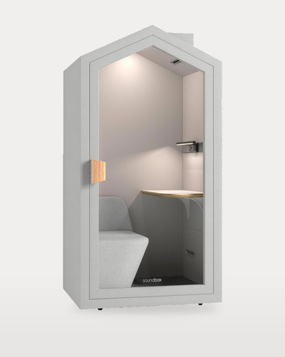 Soundbox Home Pod in light grey felt, a one-person pod shaped like a small house, front three-quarter view