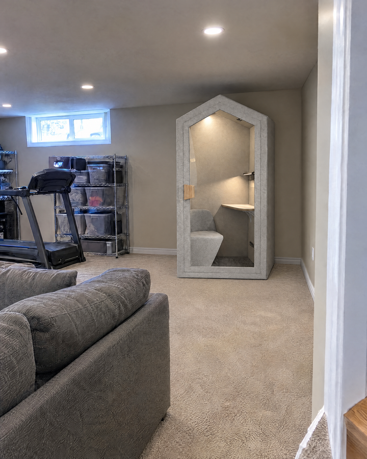 Home Pod against the wall of a finished basement under pot lights, with room above it to the ceiling. Illustration.