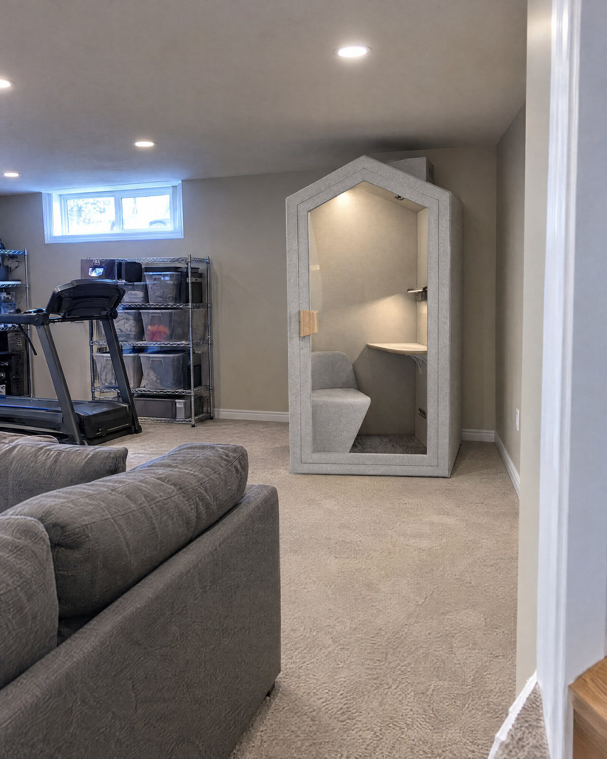 Home Pod in a finished basement under pot lights, with room above it to the ceiling. Illustration.