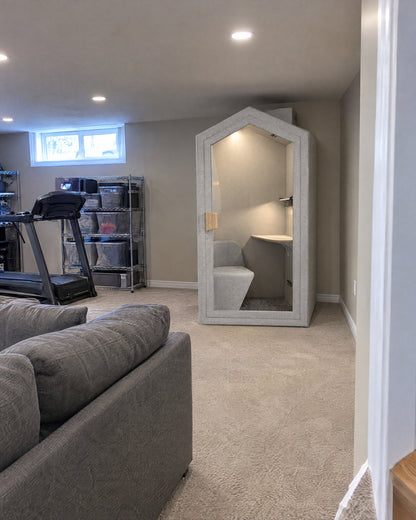 Home Pod in a finished basement under pot lights, with room above it to the ceiling. Illustration.
