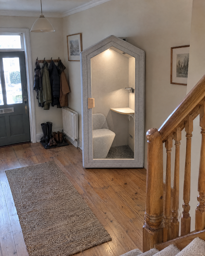 Home Pod against the front hallway wall of an older house, seen from the stairs, light on inside. Illustration.