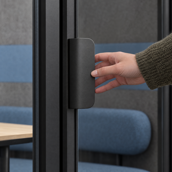 Hand reaching for the flat dark satin door pull of a SoundBox VRS Collaborative. Illustration.