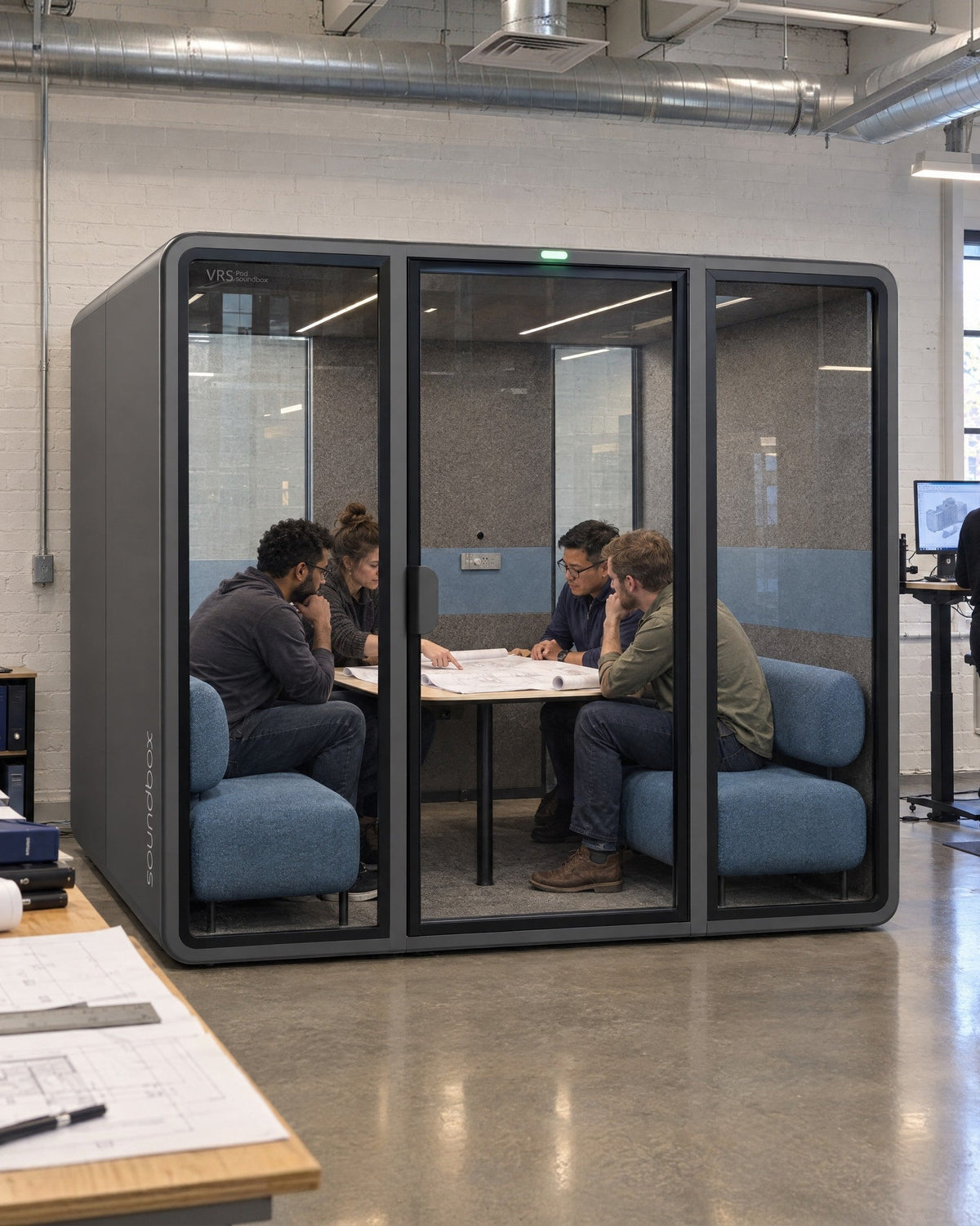 SoundBox VRS Collaborative in an engineering studio, four engineers reviewing drawings inside. Illustration.