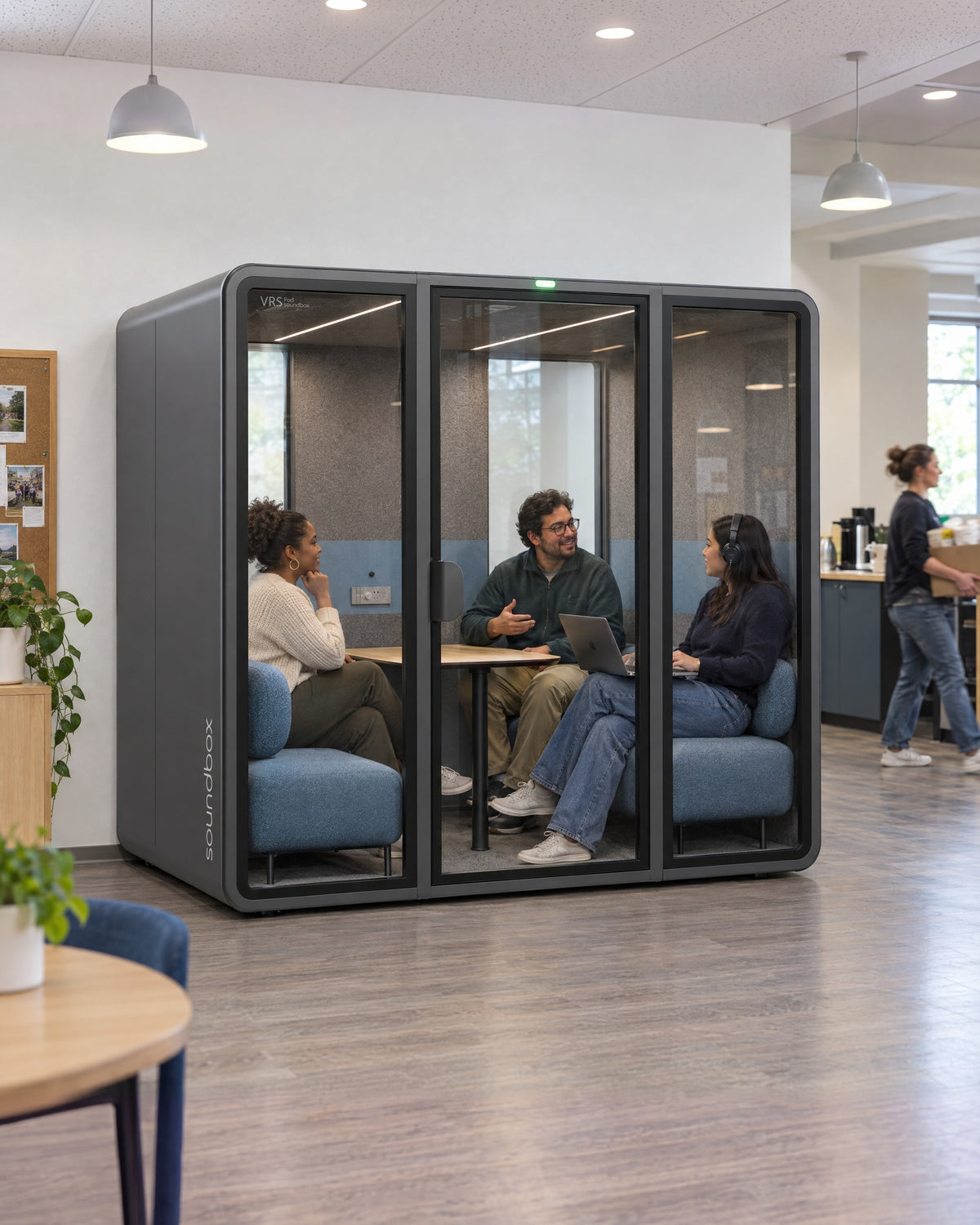SoundBox VRS Collaborative in a community centre office, three people inside on a video call. Illustration.