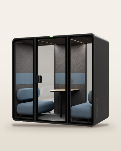 SoundBox VRS Double meeting pod: graphite shell, three glass panels with a centre door, two dusty blue sofas facing across an oak table