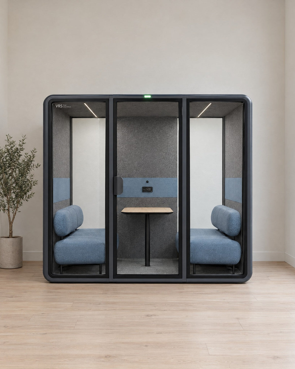 SoundBox VRS Double in a bright clinic staff area, door closed, green available light on, wide clear glass panels at both ends of the back wall. Illustration.
