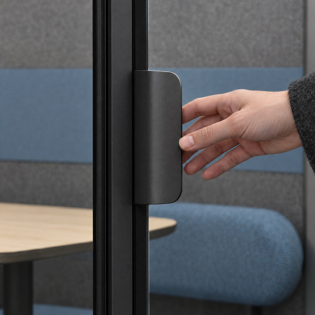 Hand opening the centre glass door of a SoundBox VRS Double by its flat dark satin pull. Illustration.