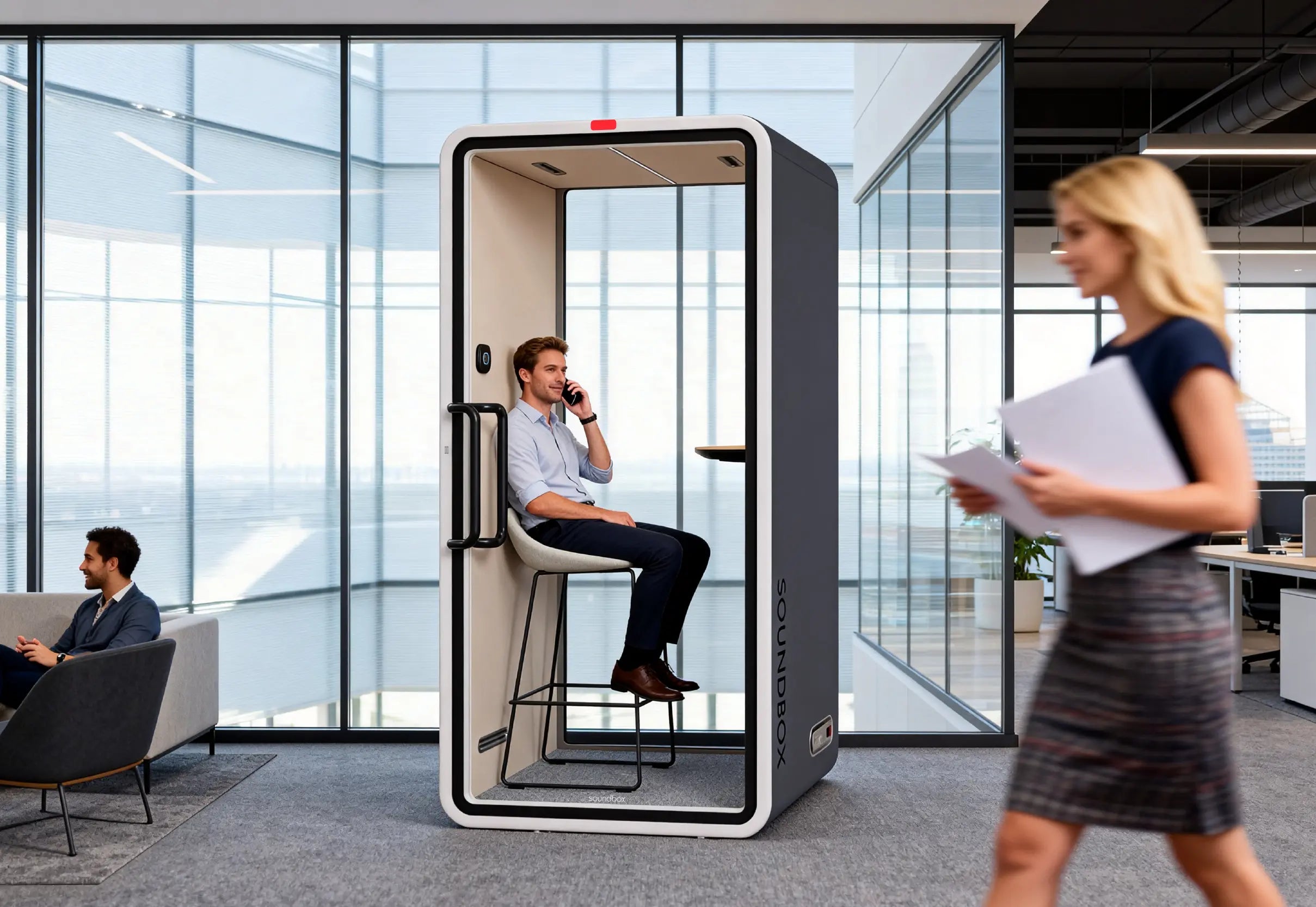 Someone taking a call inside a SoundBox VRS pod on an open office floor