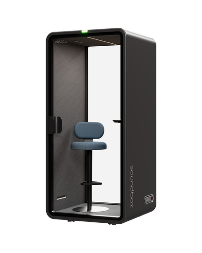 SoundBox VRS Single office pod, front three-quarter view, graphite shell with glass door, blue stool and desk shelf