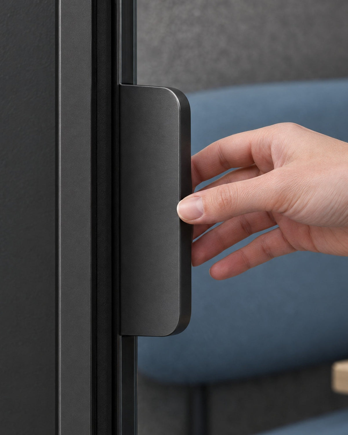 Hand opening the glass door of a SoundBox VRS Single Comfort by its flat dark satin pull. Illustration.