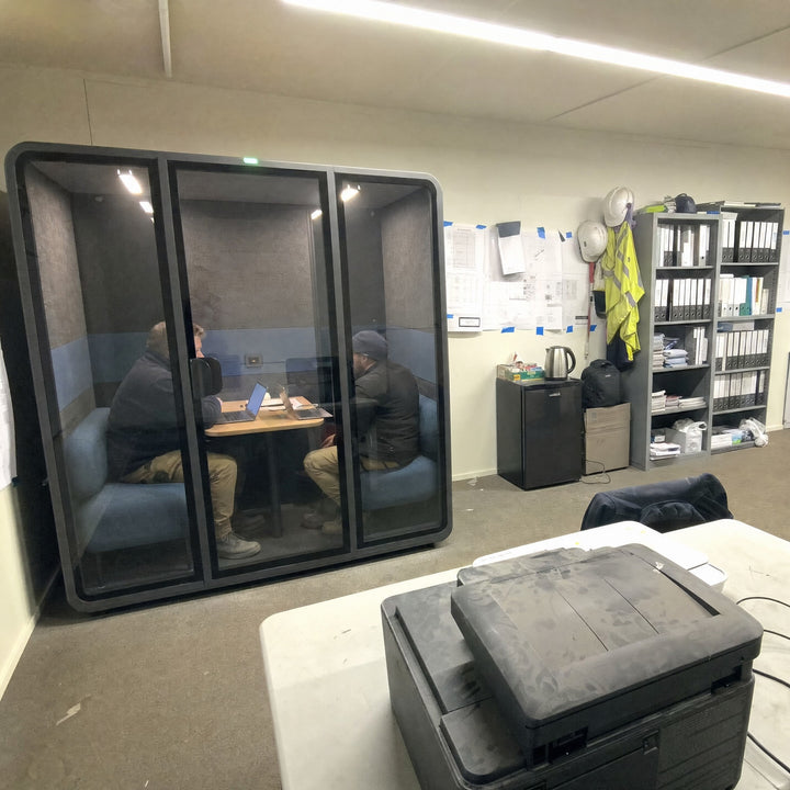 Two workers meeting inside a SoundBox VRS-ML pod in a construction company office