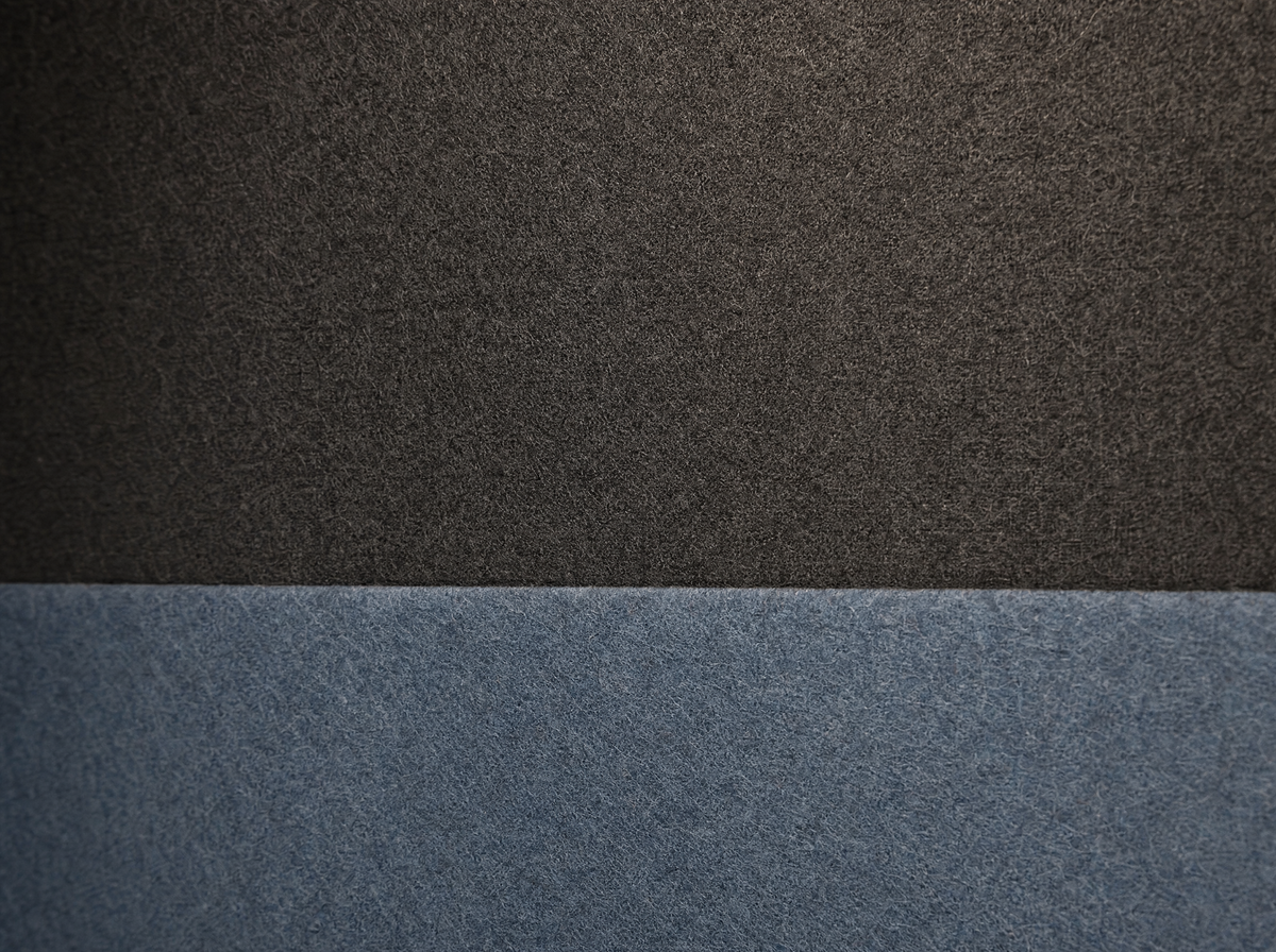 Dark grey and blue acoustic felt interior fabric of a SoundBox VRS pod