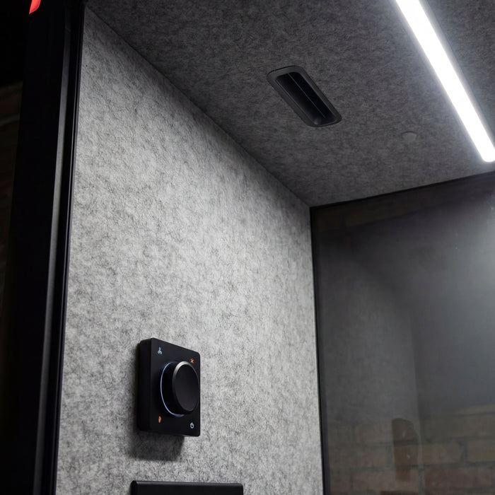 Interior corner of a Collaborative Booth showing the control dial, power outlet and ventilation