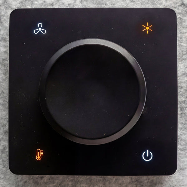 The interior control dial of a Quiet Cabins booth showing fan, brightness, temperature and power